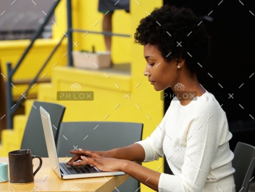 demo-attachment-1082-attractive-young-woman-using-laptop-outside-P9RLFGU@2x