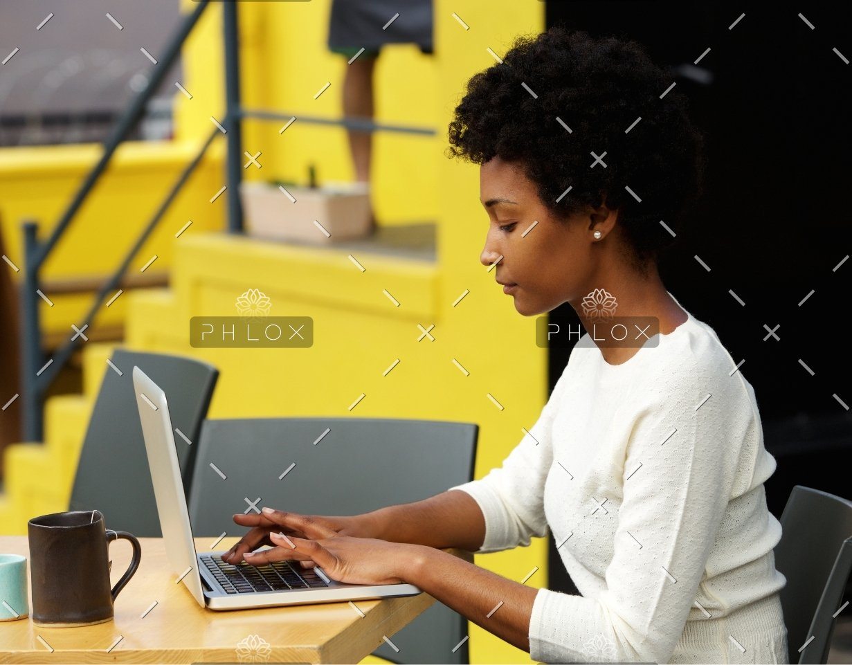 demo-attachment-1082-attractive-young-woman-using-laptop-outside-P9RLFGU@2x